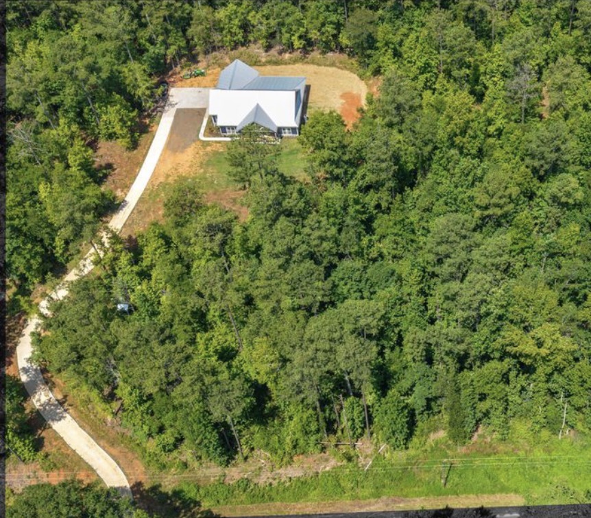 Aerial view of a home and surrounding property